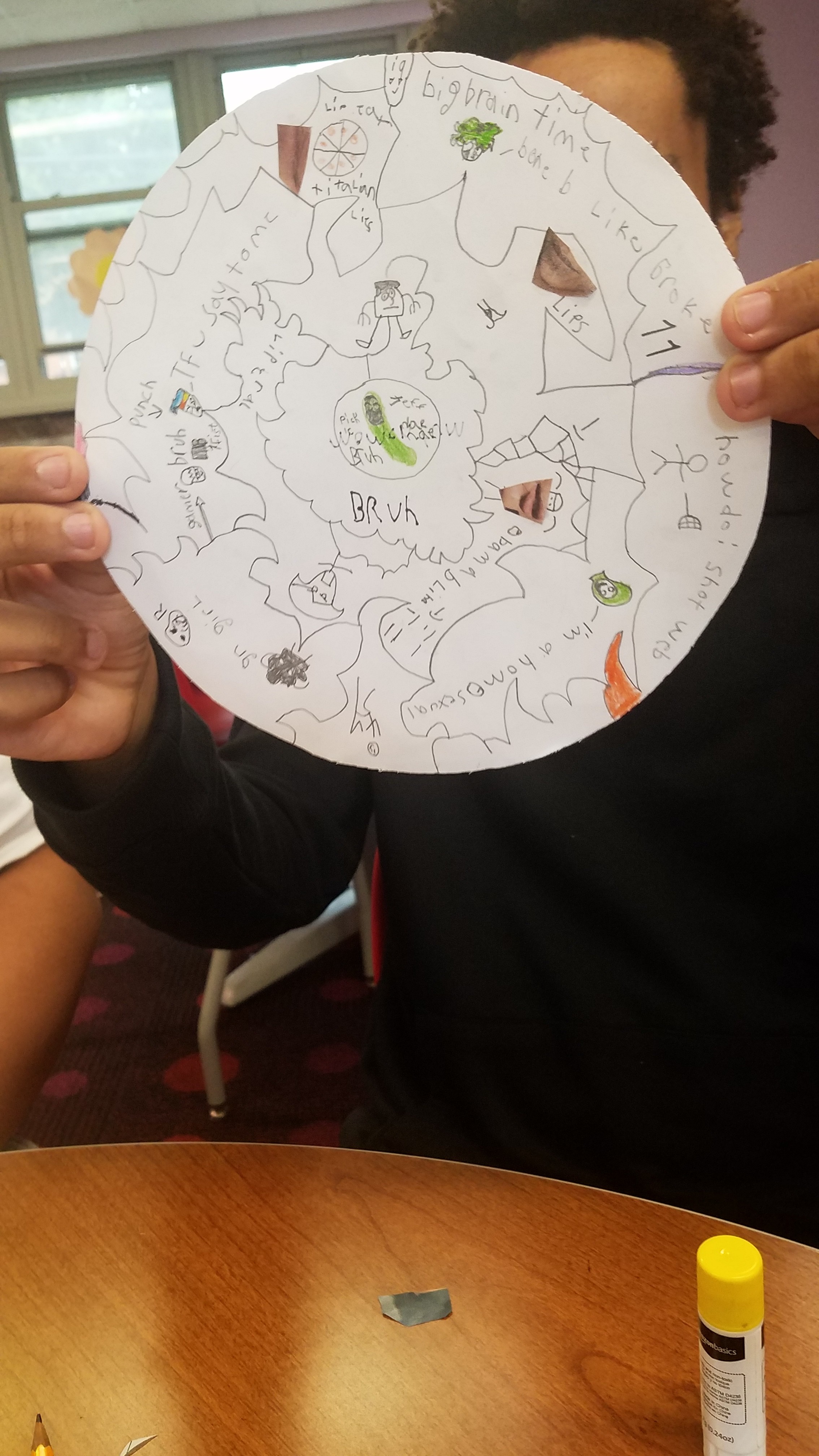 A workshop participant shows off his Magical Mandala, an enchanting pattern drawn onto a white circle.